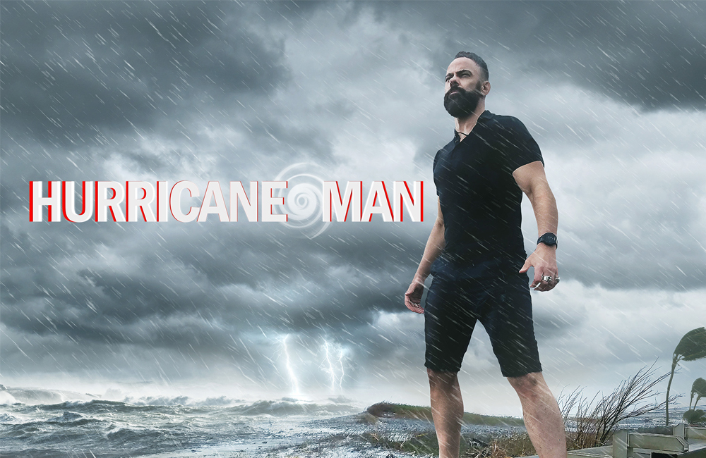 hurricane Man thumbnail featuring a bearded person in shorts and a t-shirt standing on the coast while a storm rages in the background